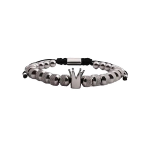Detail showing the silver crown charm and black braided rope on a stainless steel bracelet