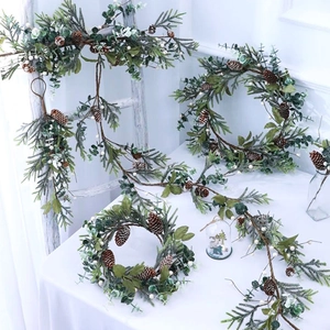 Christmas wreath and garland set with pine cones, needles and white berries for home decor