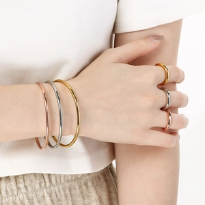Minimalist 18k gold plated stainless steel bangles and rings set in three metallic colors