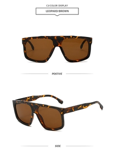 Detail view of leopard print oversized sunglasses with dark brown lenses and thick frames