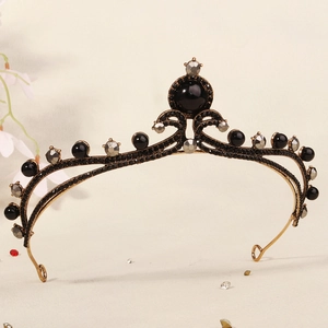 Close-up of vintage black bridal crown with bronze frame and dark crystal details