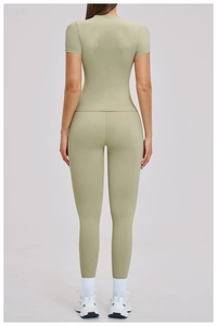 Back view of high-waist yoga pants and tight top in sage green athletic fabric