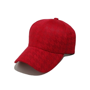 Detail of red houndstooth texture on a stiff crown baseball cap for women