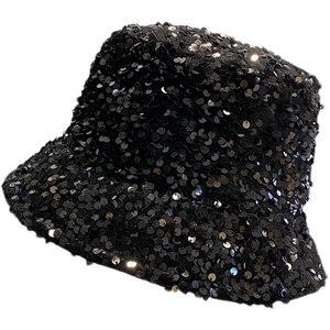 Detailed view of shimmering black sequins on a fashionable street style bucket hat
