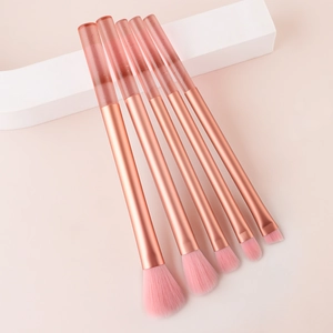 Detailed view of 5 mini makeup brushes with glitter crystal handles and pink soft bristles