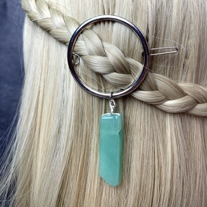 Green crystal round hair clip accessory shown on a blonde braided hairstyle