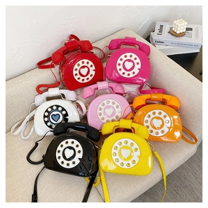 Detailed arrangement of colorful retro telephone-shaped crossbody bags in glossy patent leather
