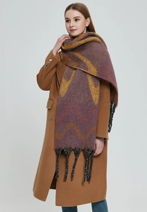 Detail of purple and yellow wave pattern scarf with black fringe tassels on a model