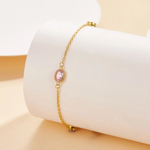 Elegant S925 silver gold-plated bracelet featuring a pink oval gemstone on a white stand