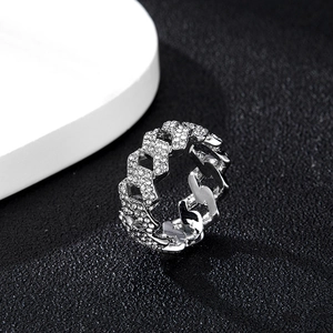 Sparkling Cuban link ring for men with pavé rhinestones on black textured surface