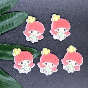 Close-up of five pink-haired cartoon character resin charms for DIY phone case crafts