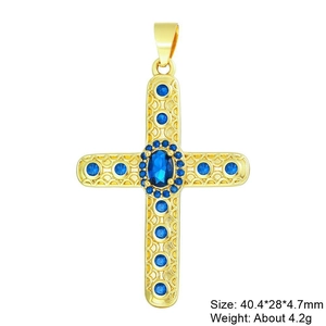Macro shot of a gold-plated cross pendant with vibrant blue zircons on a white background