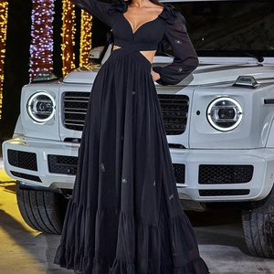 Detail of elegant black chiffon dress featuring unique waist cutout and spider rhinestone decor