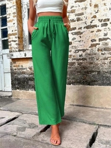 Détail du pantalon vert à taille haute et jambe large en tissu texturé avec cordon de serrage