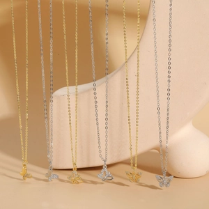 Detailed close-up of butterfly zircon pendants in gold and silver finish on chains