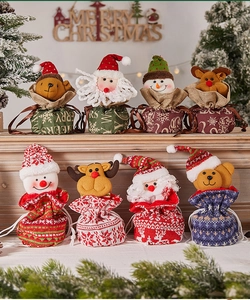 Detail of Christmas gift bags featuring 3D Santa, Snowman, and Reindeer plush designs