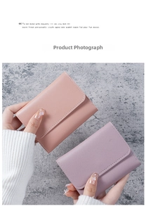 Mini trifold faux leather wallets in pastel pink and purple on marble surface