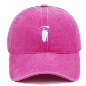 Close-up of Grim Reaper white embroidery on vintage washed pink cotton baseball cap
