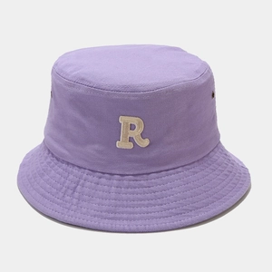 Detailed close-up of light purple cotton bucket hat featuring white embroidered R letter
