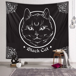 Detail view of Black Cat tapestry hanging on a white brick wall in a cozy room setting