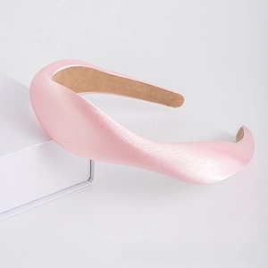 Macro shot of thick light pink satin sponge headband showing soft texture and anti-slip lining