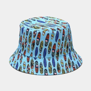 Close-up of sky blue bucket hat with surfboards pattern and Ocean Calling text