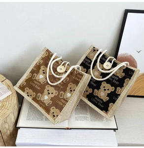 Detail of vintage bear print jute lunch bags in brown and black with button closure
