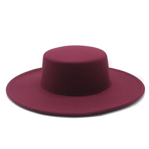 Close-up of a dark red wool felt flat top hat with a wide 10cm brim and smooth texture