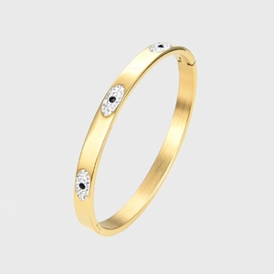 Elegant gold-plated stainless steel evil eye bangle featuring sparkling crystal settings