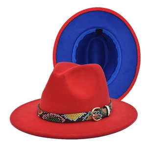 Detail of red fedora hat with snakeskin band, gold metal buckle and blue lining contrast