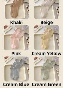 Detail of soft cotton crew socks showing six pastel colors with small white fabric labels