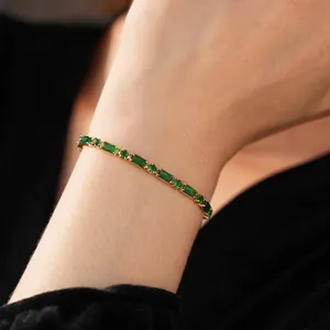 Elegant gold plated bracelet with emerald cut green stones and sparkling zircons for women