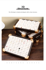 Macro detail of walnut wood jewelry tray with gold corners and beige velvet lining