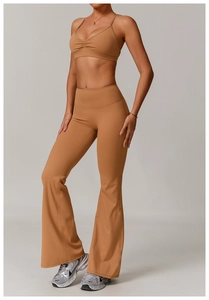 Close-up of caramel yoga set featuring ruched V-neck sports bra and flared yoga pants