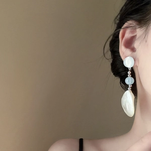 Elegant silver drop earrings with milky resin beads and baroque pearl pendant on model