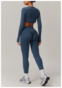 Detail view of slate blue yoga set featuring scrunch butt leggings and long sleeve top
