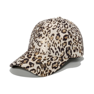 Women's cream baseball cap featuring metallic gold leopard print and curved brim style