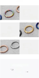Macro detail of twisted stainless steel rings showing polished texture and various colors