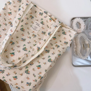 Floral cotton tote bag with vintage ink splatter pattern and textile label detail