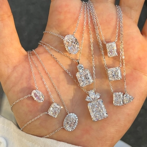 Macro detail of S925 silver necklaces with radiant and oval cut gemstone pendants