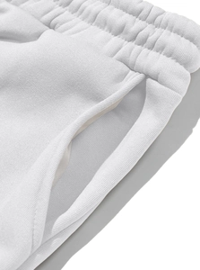 Macro detail of high-gram knit texture and side pocket on white fleece joggers pants