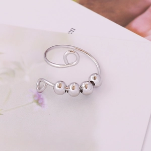 Silver adjustable spiral ring with four rotating beads for anxiety relief and focus