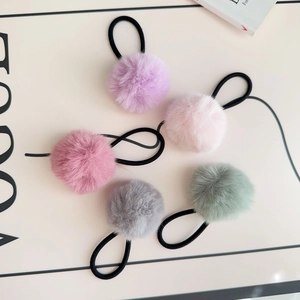 Detailed set of 5 fuzzy pom-pom elastic hair ties in pastel colors on a white background