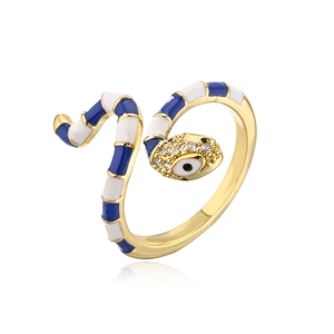 Macro detail of gold plated snake ring with blue enamel and zircon evil eye design