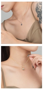 Close-up of gold and silver Evil Eye necklaces with blue crystals worn on model neck