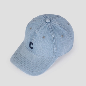 Detailed close-up of light blue denim baseball cap with navy blue embroidered C logo