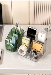 Detail view of green and transparent textured desktop organizers with office supplies