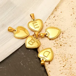 Golden heart initial charm in 18K gold plated stainless steel with beaded edge detail