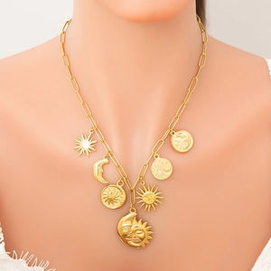 Golden paperclip chain necklace with celestial sun and moon charms on model