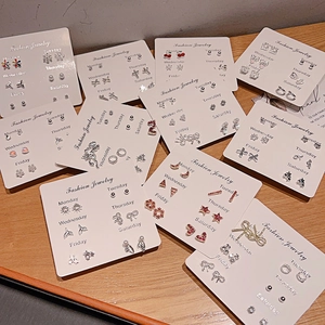 Set of 6 pairs minimalist stud earrings including heart and flower designs on a card